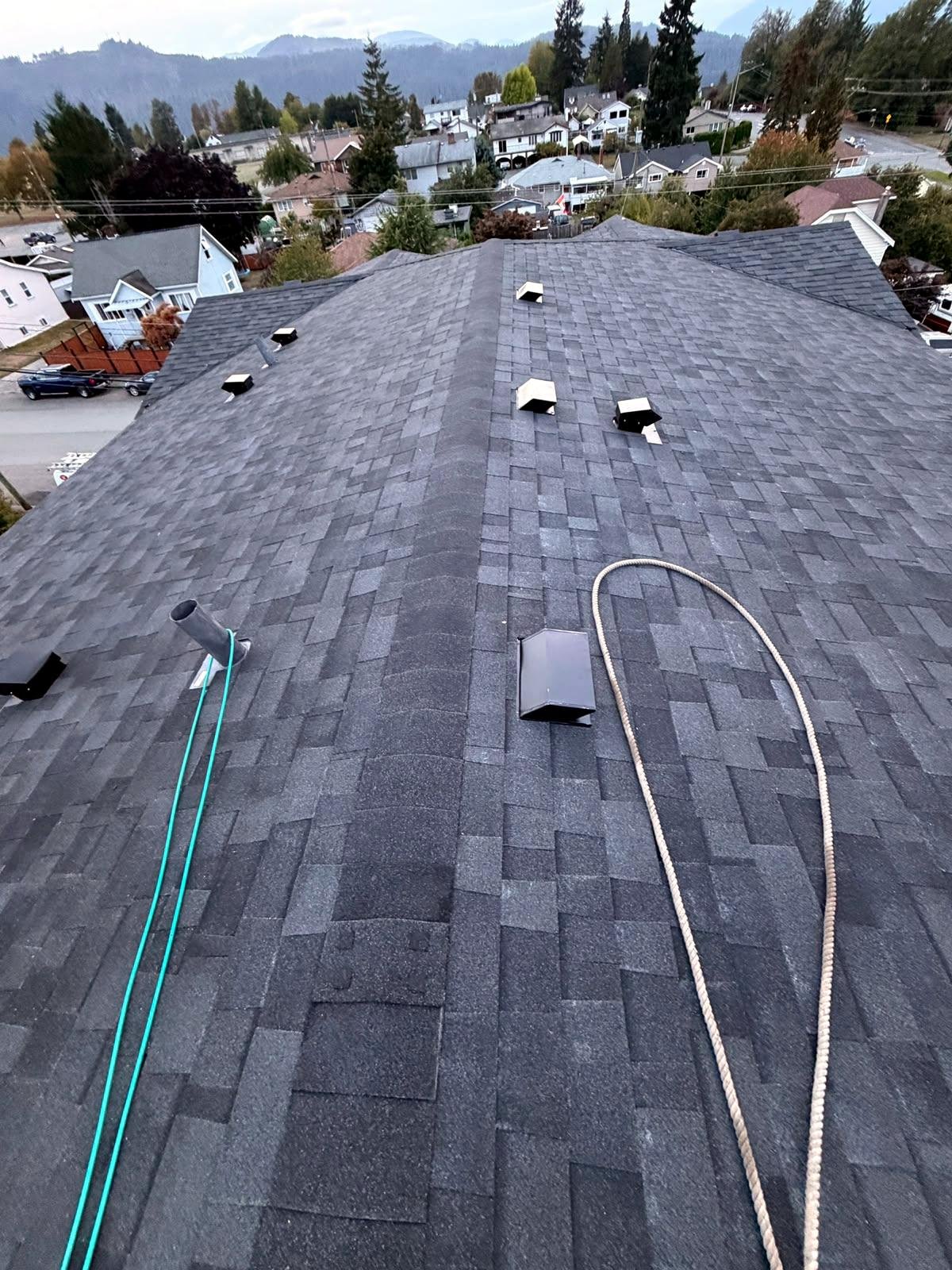New dark grey shingle roof with upgraded ventilation in Parksville