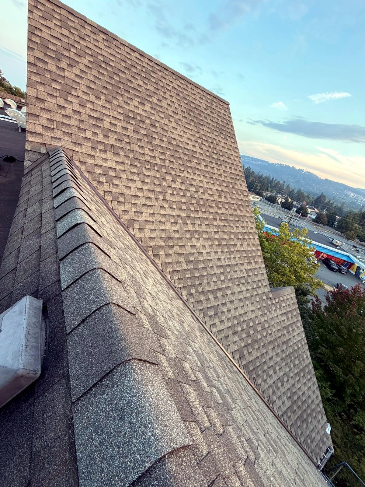 Close-up of premium brown architectural shingles and ridge caps in Ladysmith